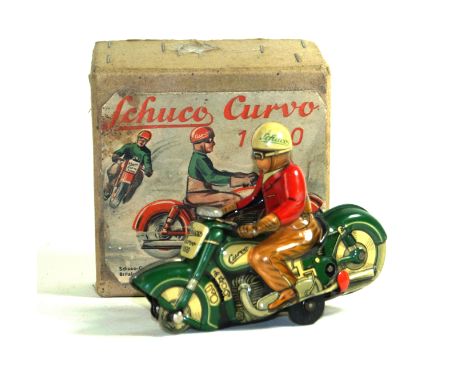 A Schuco Curvo 1000 clockwork tinplate motorcycle rider Dark green motorcycle, the driver in brown trousers and red jacket an