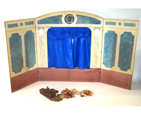 A wooden puppet theatreWith stage, with trap door to floor, blue curtains, hand painted backdrops, open fire and four card pr