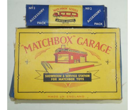 A boxed Matchbox garage showroom and service stationWith yellow forecourt and red building with metal petrol pumps and Esso s