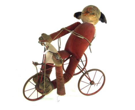 A Chad Valley Hygienic Toys felt Bonzo dog riding a red painted metal tricycle  Height of figure 38cm.