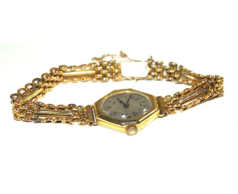 An Art Deco 9k gold manual wind Ladies bracelet wristwatchThe white dial, with black Arabic numerals, the canted lozenge case