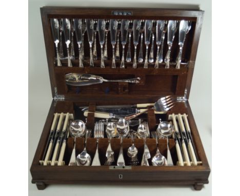 A circular 1930s oak canteen of silver plated cutleryThe fitted interior containing a mixed selection of flatware, to include