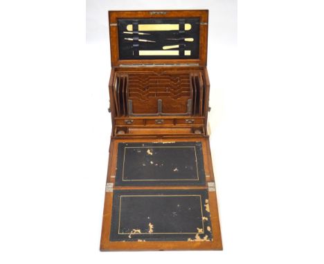 An early 20th Century light oak stationery cabinetThe hinged cover lifts to reveal a blue leather section with ivorine ruler 