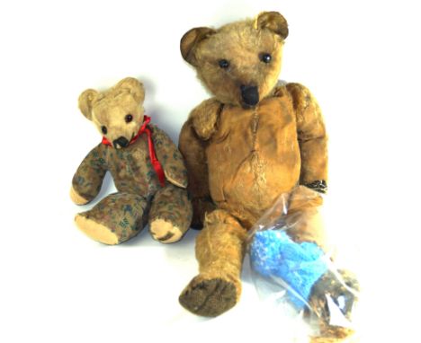 An early large gold plush teddy bearWith pointed snout and leather button eyes - very badly worn and with damaged leg, height