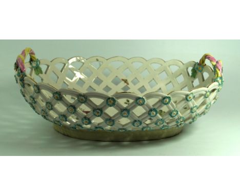 A 19th Century hard-paste porcelain basketPossibly Derby, having floral encrusted decoration with rope twist handles, and han