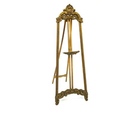 A highly decorative and ornate giltwood easel, circa 1900Decorated with ornate scrolls and foliate motifs and featuring a sli