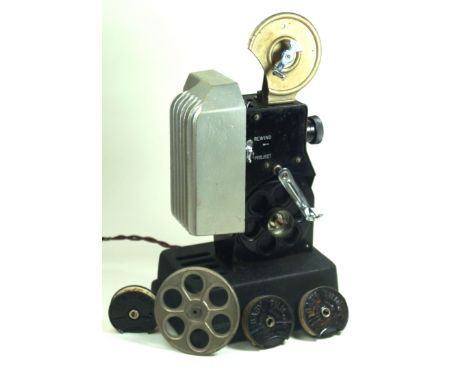 A vintage Dekko projector Together with assorted Pathescope reels to include Donnington Park, Chester motor club grass track 