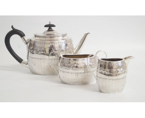 A late Victorian hallmarked silver three piece tea set in the Georgian taste by William Hutton & SonComprising semi fluted, c