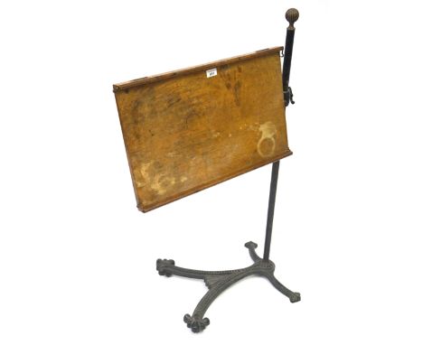 A Victorian reading stand by William Tonks & SonsThe adjustable oak stand raised on a cast iron column with brass fluted sphe