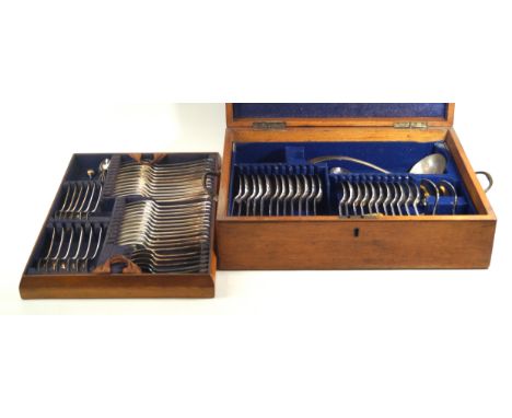 An Edwardian light oak canteen of silver plated cutleryThe hinged lid with inset shaped brass cartouche, enclosing a lined an