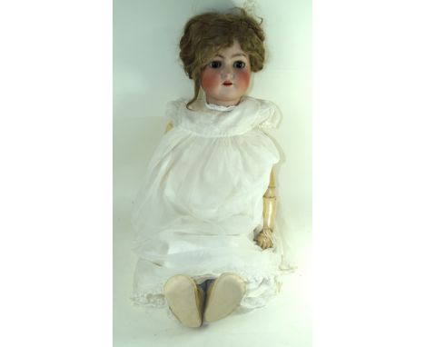 A fine quality large German bisque headed dollWith dark blonde wig, open/shut brown eyes, open mouth, impressed marks K* and 