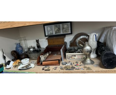A carved African head table lamp together with cap badges, electroplated flatwares, oak clock, coins, glass bowls, postcards,