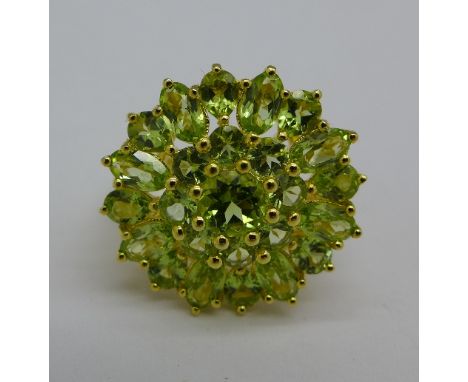 A silver gilt and peridot cluster ring, R