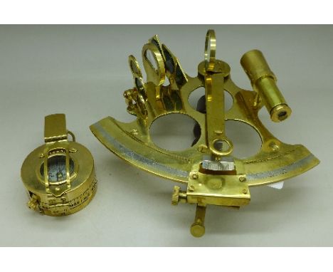 A brass reproduction compass and a brass reproduction octant