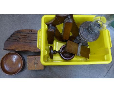 A box of wooden ware, including a letter rack, tea caddy, barleytwist candlestick, hall tidy and a brass oil lamp
