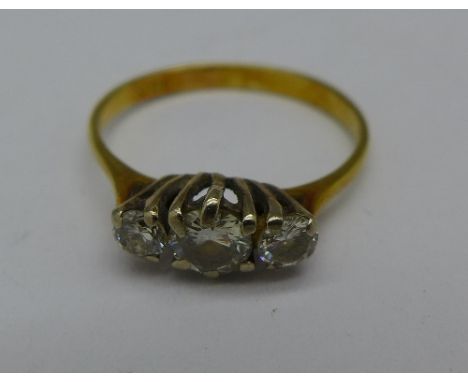 An 18ct gold and three stone diamond ring, 1.7g, K