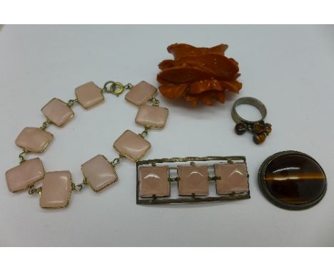 A rose quartz brooch and similar bracelet, an amber coloured carved flower brooch, a tigers eye brooch and a ring