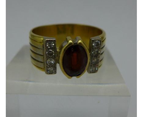 An 18ct gold, red stone and diamond ring, 8.8g, R