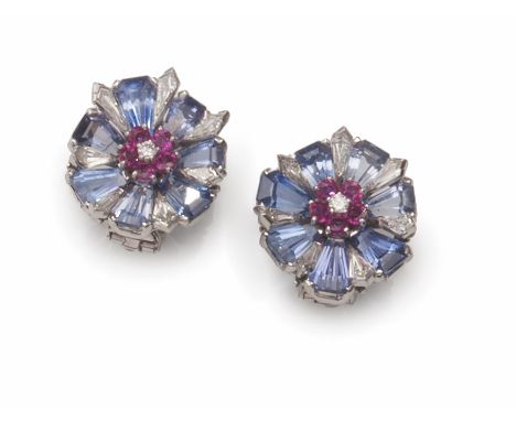 


A PAIR OF AMERICAN 18K WHITE GOLD, DIAMOND AND RUBY EAR CLIPS, NEIMAN MARCUS 
New York, circa 1990 
Shaped as a sapphire-s