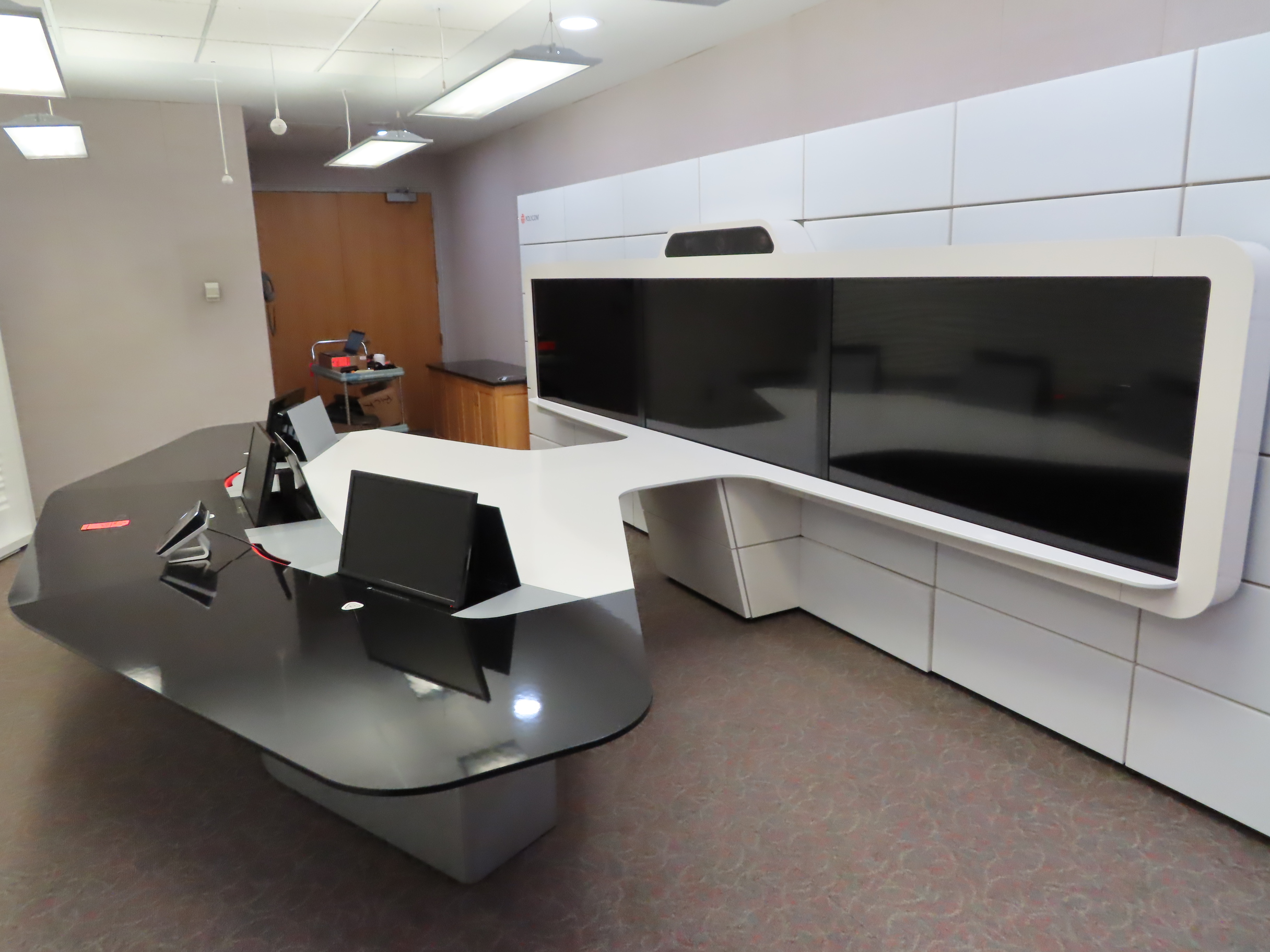 Video conference room including (3) 65" screens, (3) 19" retractable screens, (3) cameras