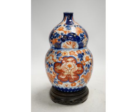 A Japanese Imari double gourd flask on stand, 23cm high. Condition - gilding worn otherwise good
