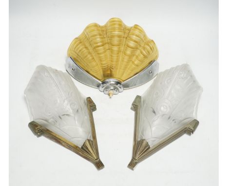 An Art Deco clam shell wall light and a pair of Art Deco wall lights, 30cm high (3). Condition - fair The pair pressed design
