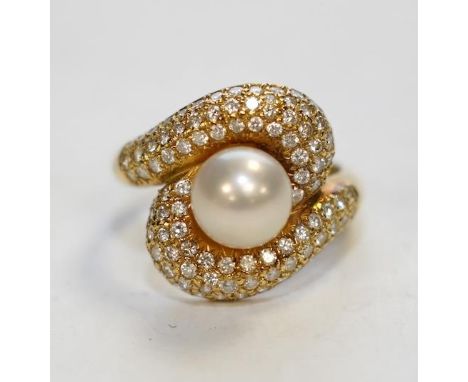 A modern 18ct gold, single stone cultured pearl and diamond chip cluster set dress ring, size M, gross weight 7.5 grams. Cond