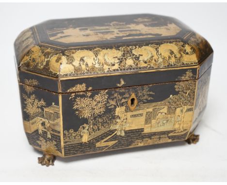 A mid 19th century Chinese export black and gold lacquer tea caddy, retaining engraved pewter tea canisters, raised on paw fe