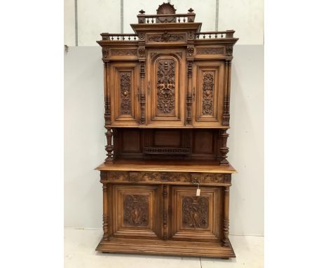 A late 19th century Continental carved walnut buffet, width 150cm, depth 58cm, height 270cm.  Condition - good