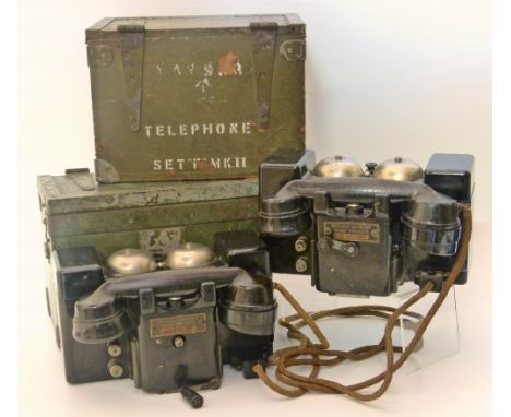 Two WWII British Army field telephones each with Bakelite casing marked Telephone Set "F" Mark II TMC, both contained in gree