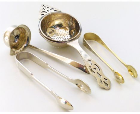 Four silver items comprising Victorian sugar nips, a small toddy ladle by Charles Boynton & Sons, and a tea strainer, total w