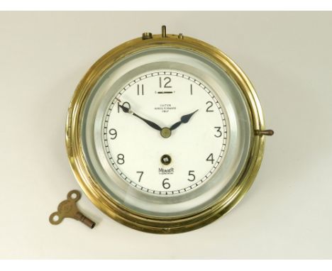 BULKHEAD CLOCK. A brass mounted bulkhead clock by Mercer of St. Albans, with key. Diameter of dial 14cm.Please note: All watc