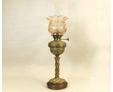 OIL LAMP. A German brass oil lamp, stamped D.R.G.M. No.125005. Copper base & peach glass shade. Height 72cm.WE CANNOT SHIP TH