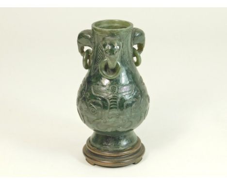 JADE. A spinach green carved jade vase on integral wooden stand. (apparently lacks lid). Height of jade 10.5cm.WE CAN SHIP TH