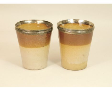 19th CENTURY SALT GLAZE. A pair of Georgian salt glaze beakers with silver mounts, possible by John Reily, London 1812. Heigh