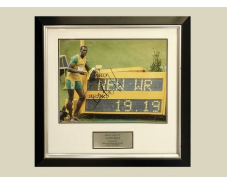 USAIN BOLT. A photograph of Usain Bolt, signed. Size of image 29 x 39cm.WE CANNOT SHIP THIS ITEM… Due to fragility, size or w