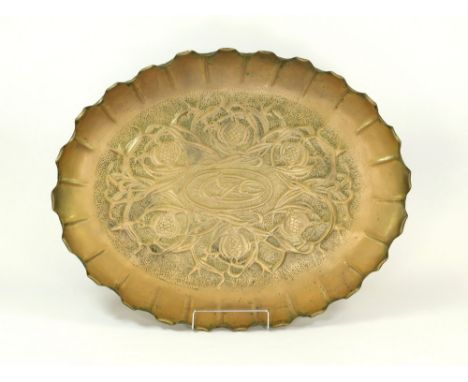 ARTS & CRAFTS. A large late 19th century Arts & Crafts shallow dish, repoussé decorated with seed pods & strap work. 67 x 51c