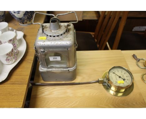 A railway lamp; and a pressure gauge 