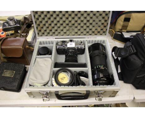 A metal case containing Canon AT1 camera with lenses and accessories 
