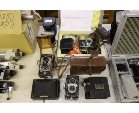 A Zeiss Ikon folding camera; a Yashica / D camera; a Yashica / A camera; a Campro cine camera; another camera and various acc