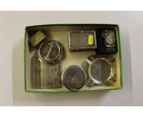 A box containing silver matchbox holder; silver ash tray; circular thermometer; silver topped jar; money clip etc. 