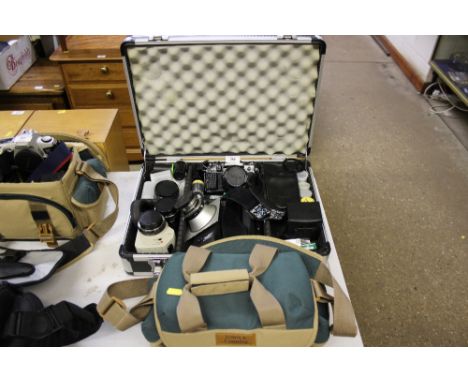 A metal case containing Canon A1 camera with various lenses, accessories and a carrying bag 