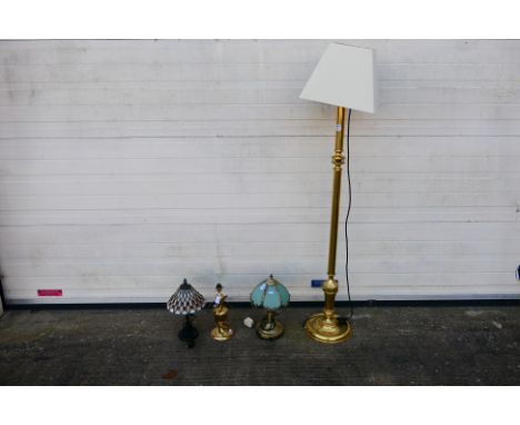 A brass standard lamp, approximately 133 cm to light fitting and three table lamps to include one Tiffany style example. [4].