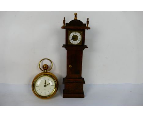 Two mantel / desk clocks comprising a Westclox in the form of a pocket watch, 14 cm (d) and one in the form of a longcase clo