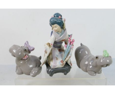 A Lladro figure depicting a Japanese lady in traditional dress, # 1450 Kiyoko, 19 cm (h) and two Nao comic hippopotamuses. [W