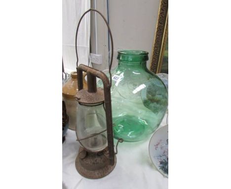 A glass carbide and a hurricane lamp.