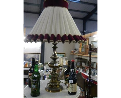 A brass table lamp with shade.