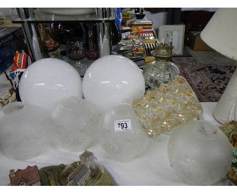 A quantity of glass lampshades and an oil lamp base (collect only)