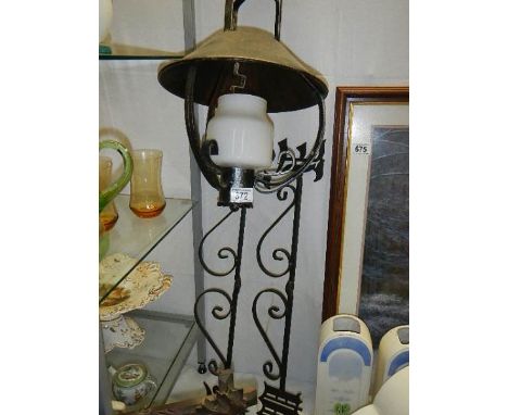 A hanging lamp and other ironwork.
