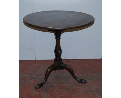 George III mahogany tea table, the saucer top on turned birdcage plinth above a turned column, tripod supports and feline fee